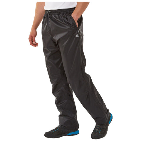 Black waterproof pants are being worn by a person who is walking. The environment suggests outdoor activity, potentially in a wet or rugged setting, given the pants' design.