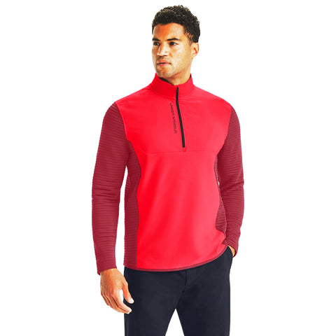 A man wearing a bright red half-zip athletic shirt with textured sleeves stands confidently against a plain white background, showcasing casual sportswear style.