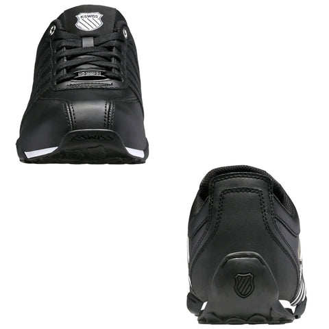 Black athletic shoes are displayed from the front and rear angles showcasing a sleek design with white accents and a logo emphasizing a sporty context suitable for casual or active wear.