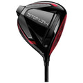 A golf driver prominently features a sleek black and red design with the word "STEALTH" displayed. It is positioned for use on a golf course, ready for a powerful swing.