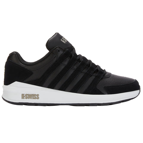 A black athletic shoe with a textured surface features multiple horizontal straps and a white outsole positioned on a plain background. The design emphasizes functionality and style.