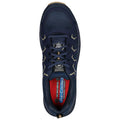 A navy athletic shoe rests on a flat surface showcasing its textured upper material padded tongue and vibrant red inner lining demonstrating comfort and style for various activities