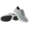 A pair of gray athletic shoes rests side by side positioned with the soles facing up showcasing a textured surface and a sleek design suitable for running or sports activities.