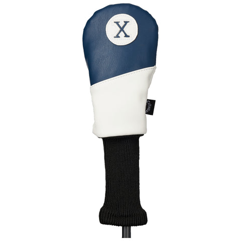 A golf club headcover is positioned upright featuring a blue and white design with a circular emblem displaying the letter X on top and a black knitted neck for grip.