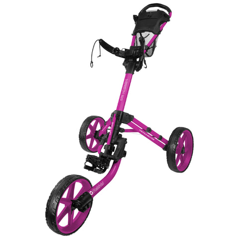 A pink golf push cart stands upright with three wheels and handles. It is designed for carrying golf bags on the course, showcasing a sporty and functional design in an outdoor setting.