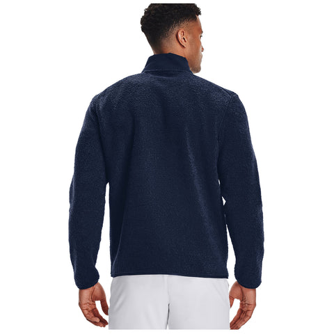 A person wearing a dark blue fleece jacket stands with their back to the viewer in a neutral or plain background, showcasing the jacket's texture and collar.