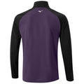 A long-sleeved athletic shirt features a purple back and black sleeves with a high collar and a logo on the upper back. It is designed for sports or outdoor activity.