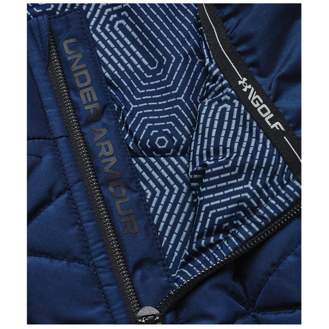 A navy quilted jacket features a geometric inner lining and visible branding for Under Armour and Golf with a zipper partially open revealing the interior design pattern.