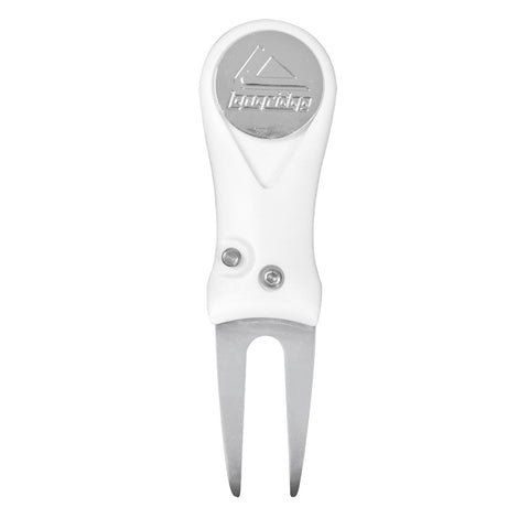 A white golf divot tool features a forked metal end for lifting grass and a rounded top for grip, typically used on golf courses to repair turf damage.