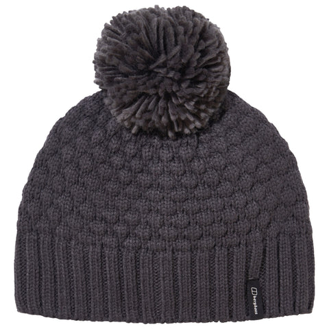 A dark gray knitted beanie rests upright featuring a large pom-pom on top and a ribbed hem at the bottom providing warmth and style for cold weather conditions.