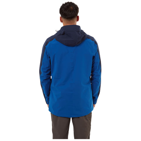 A person wearing a blue jacket with a hood stands with their back facing the viewer against a neutral background, suggesting a casual or outdoor context.