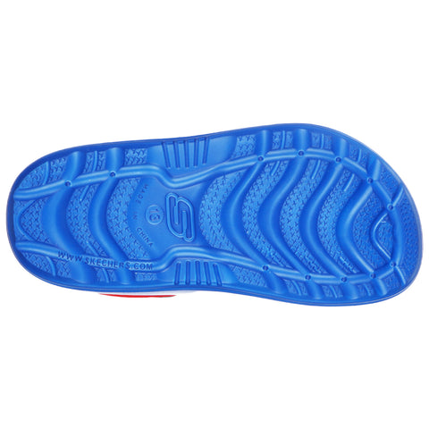 A blue sneaker sole is displayed with a textured pattern designed for grip while resting on a flat surface in a neutral setting. The brand logo S is visible.