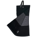 A black and gray golf towel is folded displaying varying textures including honeycomb and stripes with a hanging loop on top set against a plain background.