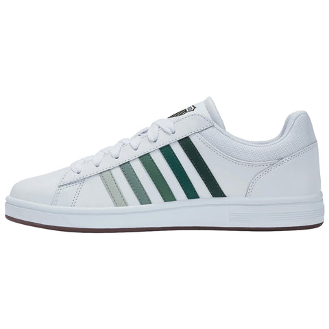 A white sneaker features three green stripes on the side with a smooth rubber sole showcasing a stylish and sporty design ideal for casual wear or athletic activities.