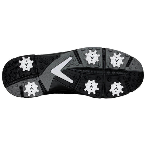 A black and grey athletic shoe sole features prominent white spikes designed for traction on grass or turf surfaces showcasing intricate tread patterns for stability during sports activities.