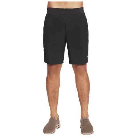 Black shorts are worn by a male figure standing upright in a neutral setting showcasing a casual style with a comfortable fit and paired with light brown shoes.