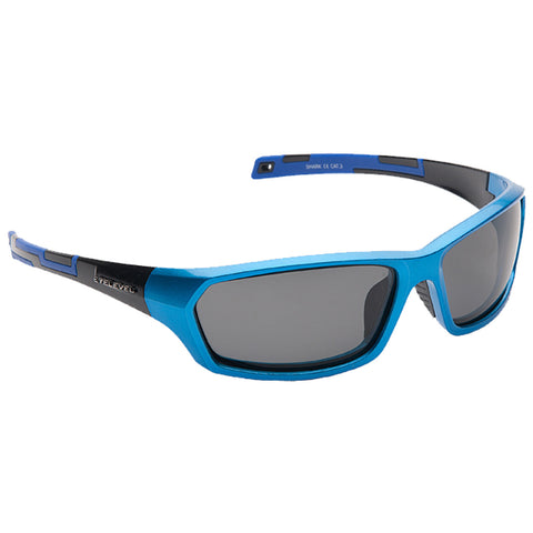 A pair of blue sunglasses with dark lenses rests against a plain white background showcasing their angular design and sporty style ideal for outdoor activities and sun protection.