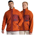 Two people are wearing matching jackets that are primarily orange with maroon accents they stand side by side against a plain background showcasing the jackets' design features and colors