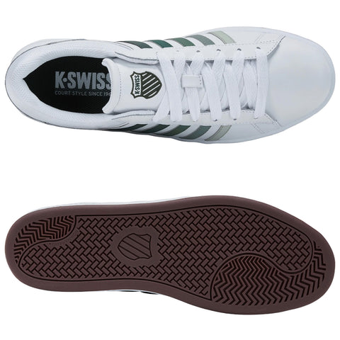 White athletic shoes with green and grey stripes are displayed from a top-down view highlighting the laces and design with a brown rubber sole below. The insole reads K-SWISS COURT STYLE SINCE 1966.