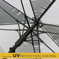 An umbrella with a metallic silver canopy is displayed from an upward angle showing the interior structure and support ribs while a yellow section at the bottom states featuring UV PROTECTION COATING