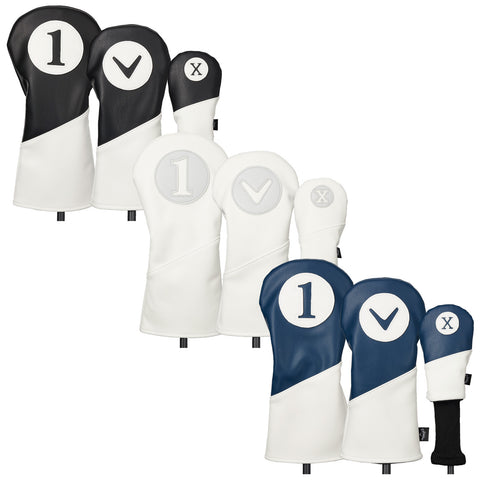 Golf club headcovers are displayed in various colors and designs. They are fitted on golf clubs to protect them, arranged in a way to showcase their unique patterns and numbers.