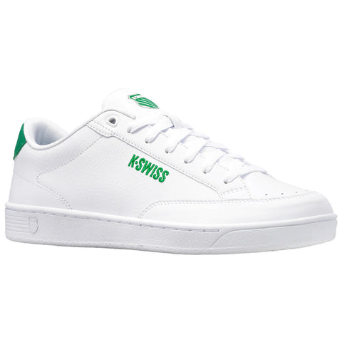 A white sneaker is displayed with green accents and branding The sneaker has a smooth texture and features laces with a logo on the tongue suggesting a sporty style