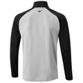 A long-sleeved athletic shirt features a gray body with black sleeve accents and a high collar the shirt is designed for sports or casual wear in an active setting.