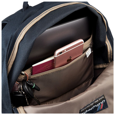 A black backpack partially opened reveals a laptop inside along with a smartphone a passport and keys placed in various compartments showing organized storage for travel or work essentials.