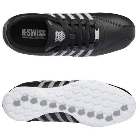 A black athletic shoe features gray stripes and a textured white outsole. The shoe is positioned facing upward, showcasing its design and logo on the tongue.