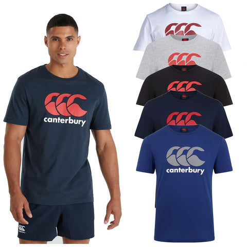 Canterbury Mens CCC Logo A man stands wearing a navy blue Canterbury t-shirt with a red and white logo while six additional t-shirts in different colors are displayed behind him in a retail context.