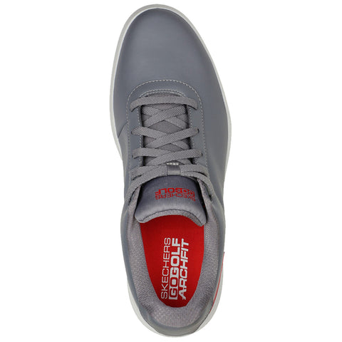 A gray golf shoe is shown from above with laces tied and a red insole visible displaying the text SKECHERS GOGOLF ARCHFIT suggesting athletic use in a golf context.