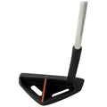 A golf putter rests vertically on a plain background the clubhead features a trapezoidal shape with a black finish and orange marking while the shaft is metallic and straight