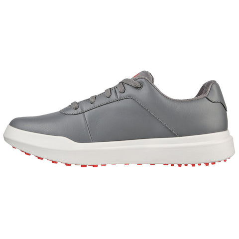 A gray sneaker is positioned sideways displaying its smooth leather upper and a thick white sole with red traction spots designed for grip in casual or athletic contexts