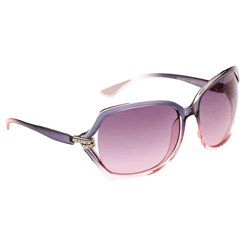 Stylish oversized sunglasses rest at an angle showcasing tinted lenses that fade from dark purple to light pink with a decorative embellishment on the frame highlighting their fashionable design.