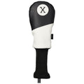 A golf club headcover is positioned upright featuring a combination of black and white leather with a circular patch marked X the knitted bottom sleeve is black