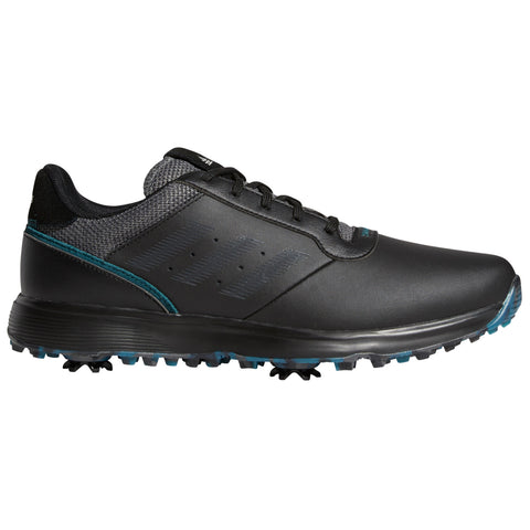 A black golf shoe is positioned sideways showing its sleek design with textured upper and teal accents while displaying spikes on the sole intended for traction on grassy surfaces.