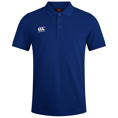 A blue polo shirt with a collar and three buttons is displayed. The shirt features a white logo on the left side reading Canterbury and the CCC logo above it.