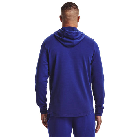 A person wearing a blue hoodie is standing facing away with their hands at their sides in a plain white background. The hoodie features a hood and is coupled with matching pants.