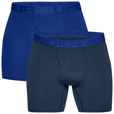 Two pairs of boxer shorts are stacked on top of each other with one in solid blue and the other in dark gray both featuring elastic waistbands with the text UNDER ARMOUR displayed prominently.