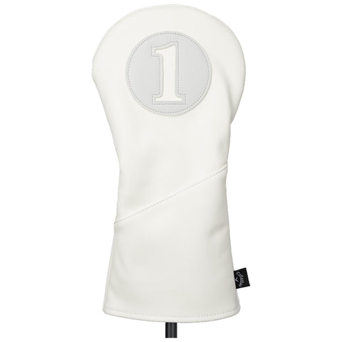 A white golf club head cover with a circular patch displaying the number one is standing upright against a plain background highlighting its smooth texture and design.