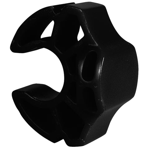 A black plastic object with a hexagonal shape featuring cutouts sits prominently. It seems designed for attachment or support, likely used in a mechanical or automotive context.