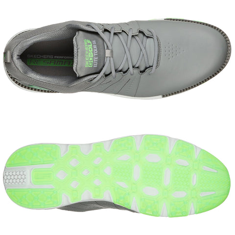 A gray athletic shoe is displayed from the top and bottom perspectives showcasing its smooth upper design and vibrant green outsole with textured patterns for traction and support.