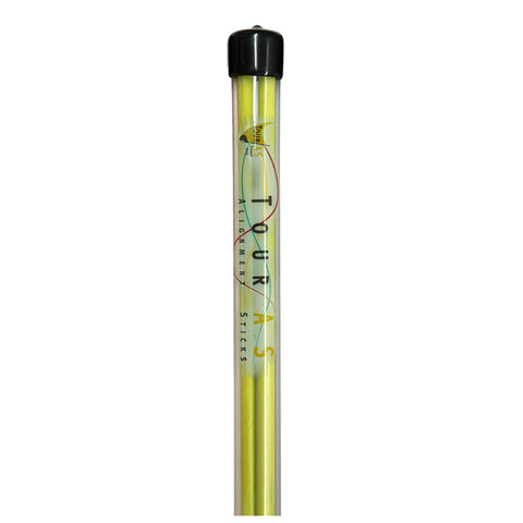 A cylindrical alignment stick stands upright with a black cap on top the stick is predominantly yellow with colorful lettering displaying "TOUR A ALIGNMENT STICKS" along its length