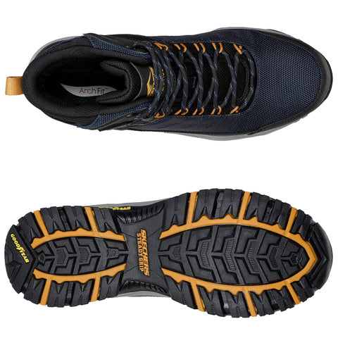 A dark-colored athletic shoe is displayed, featuring a mesh upper and secured laces. Its sole showcases a rugged design labeled Goodyear and Skechers Steady Grip, suitable for various terrains.