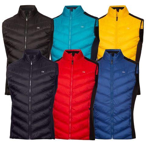 A collection of six colorful vests hangs side by side featuring a quilted design with high collars and zippers available in black turquoise red yellow and blue against a plain background.