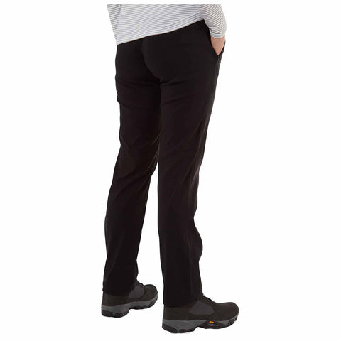 Black pants with a fitted design are being worn by a person standing with their hands in the pockets. The individual is wearing dark footwear, suggesting a casual or outdoor setting.