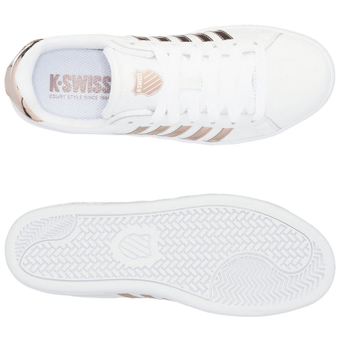 White athletic shoes feature a sleek design with metallic rose gold stripes and branding on the tongue. They are shown from a top-down view on a neutral background.