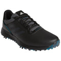 A black golf shoe features a smooth leather upper with gray mesh accents and a textured sole designed for traction on grass surfaces. The shoe is aimed at performance.