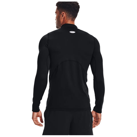 A man stands wearing a fitted black long-sleeve athletic shirt with his back towards the viewer, positioned against a plain white background, emphasizing his sleek silhouette.