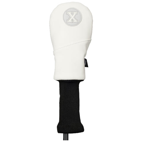 A golf club headcover is displayed standing upright featuring a white leather exterior with a circular logo and a black knitted bottom part providing protection and style for the golf club.